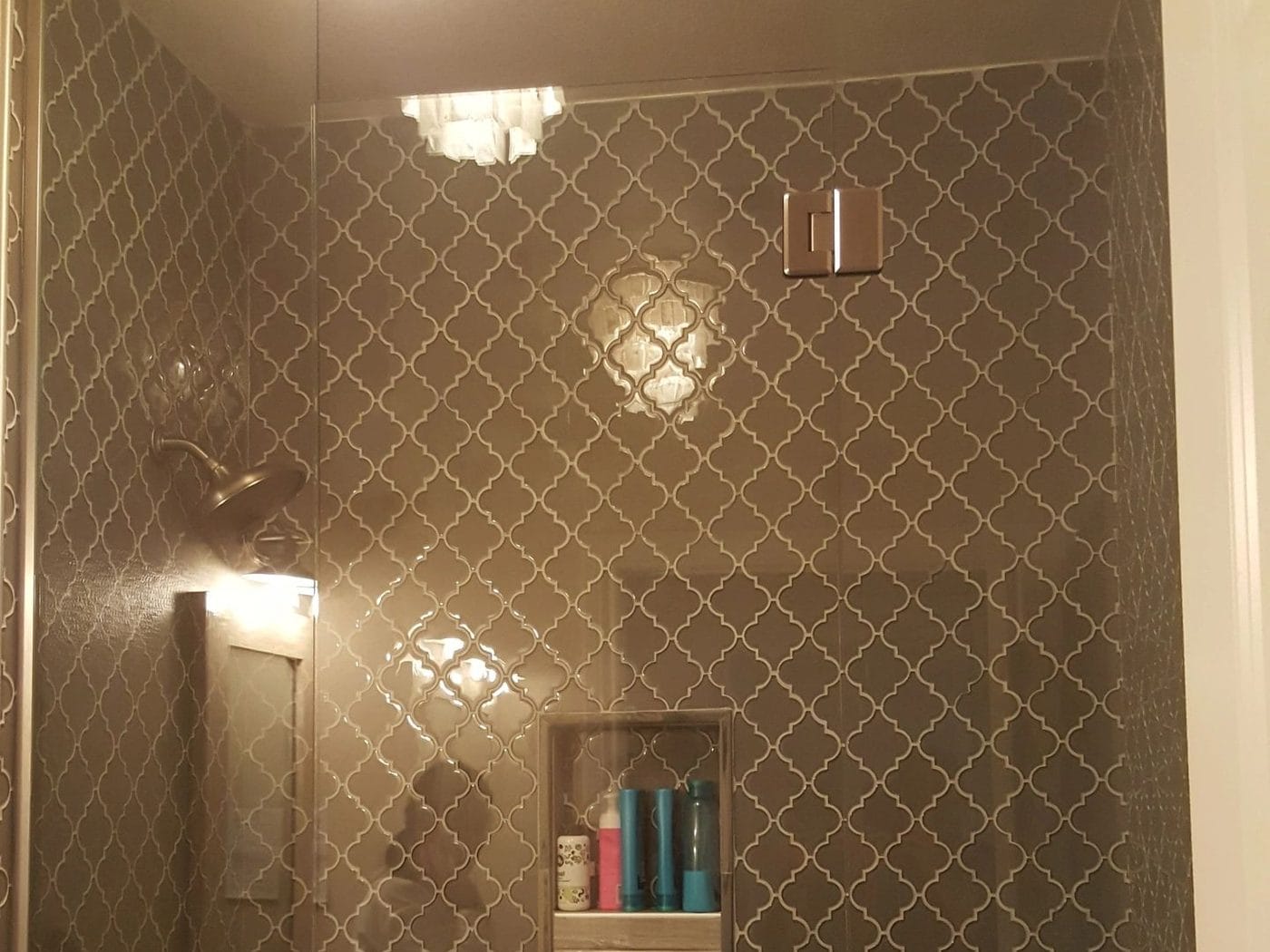 Patterned tile taken to the ceiling, with a niche set into the wall