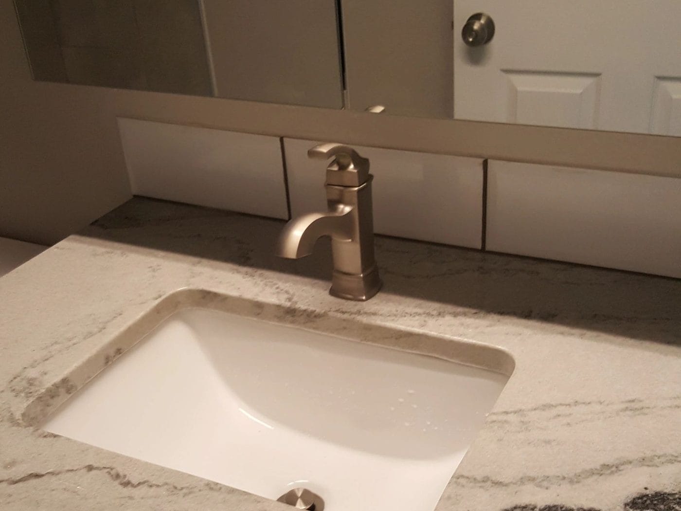 Undermount basin set into a stone top, seam polished flush