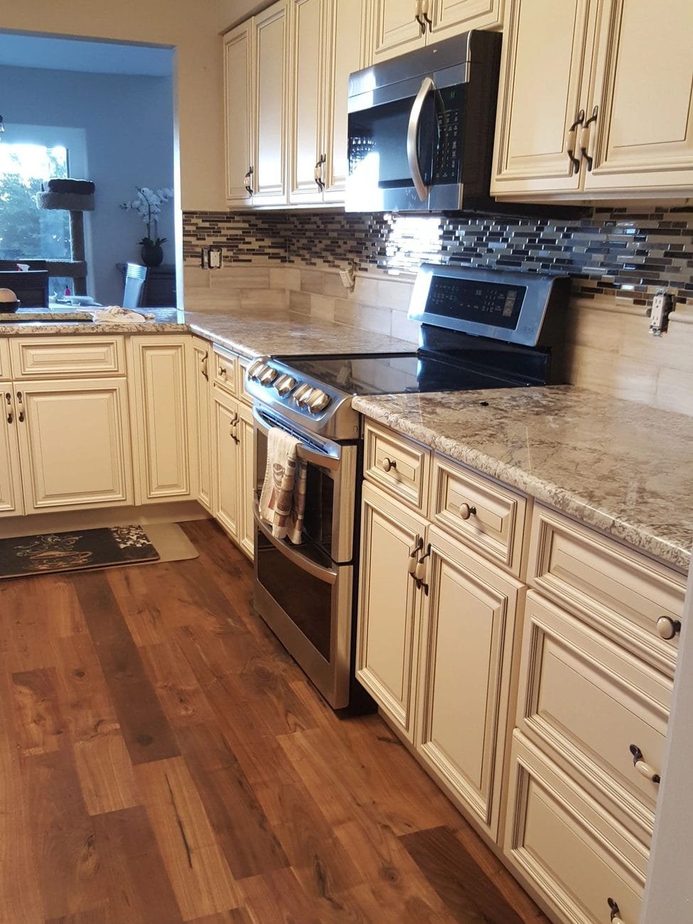 Cream cabinetry, granite counters and a full stainless run